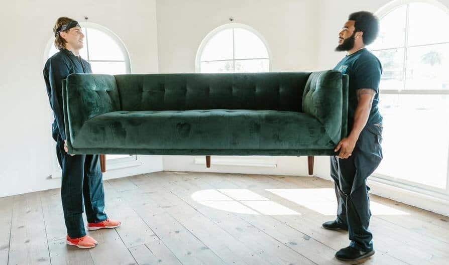 two movers moving a couch