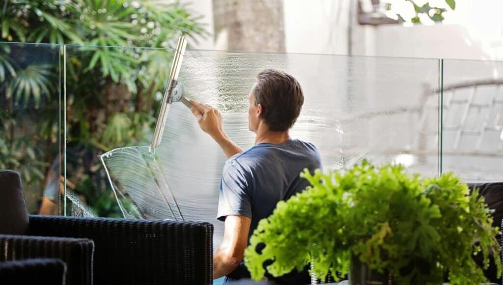 window cleaning business owner washing a window