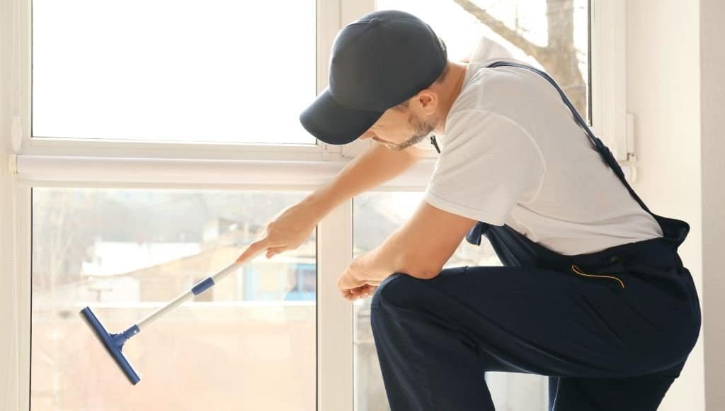 employee performing window cleaning job